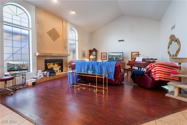 living room with high vaulted ceiling, wood-type flooring, and a fireplace