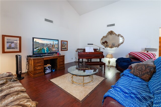 living room with high vaulted ceiling and dark hardwood / wood-style flooring