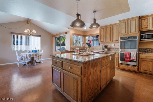 kitchen with a kitchen island, dark hardwood / wood-style flooring, stainless steel appliances, lofted ceiling, and decorative light fixtures