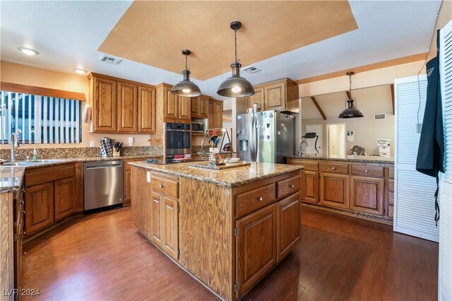 2504 Windjammer Way, Las Vegas, NV 89107 - kitchen with appliances with stainless steel finishes, dark wood-style flooring, and brown cabinets