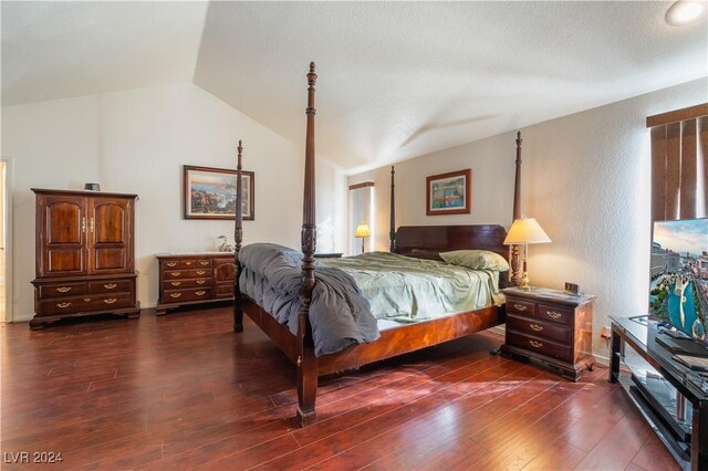 2504 Windjammer Way, Las Vegas, NV 89107 - bedroom with lofted ceiling, dark wood-style floors, and a textured wall