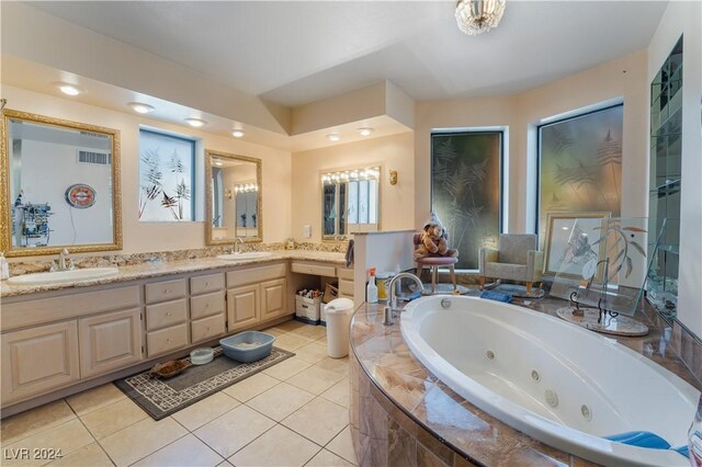 2504 Windjammer Way, Las Vegas, NV 89107 - bathroom with a tub with jets, double vanity, and tile patterned floors