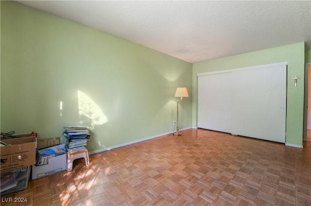 unfurnished room featuring parquet flooring