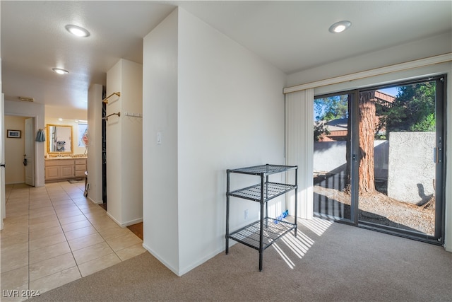 hallway featuring light colored carpet