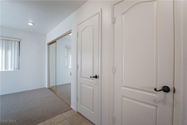 2504 Windjammer Way, Las Vegas, NV 89107 - hallway with light carpet and light tile patterned flooring
