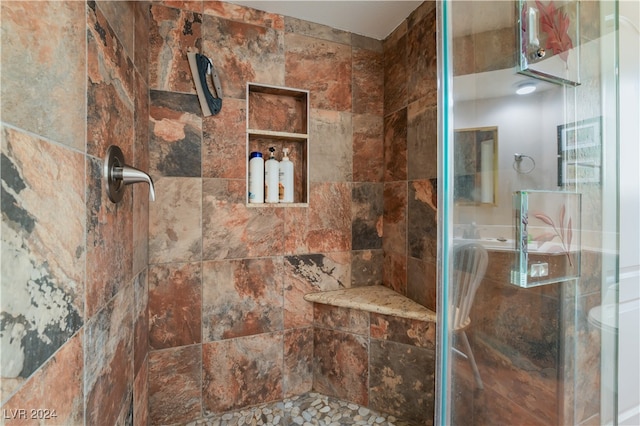 bathroom with a tile shower