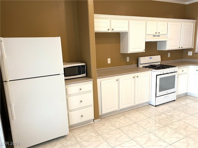 kitchen featuring white appliances and white cabinetry