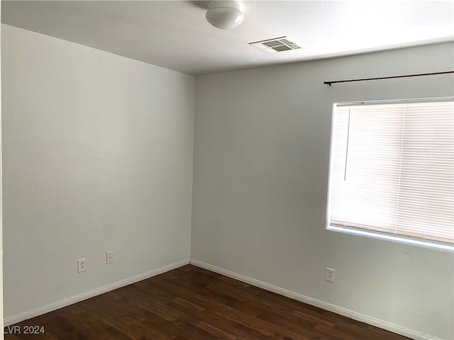 spare room featuring dark hardwood / wood-style floors