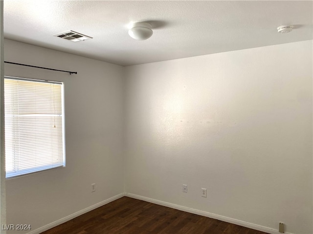 empty room featuring dark hardwood / wood-style floors