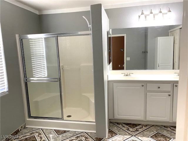 bathroom with vanity, walk in shower, ornamental molding, and tile patterned flooring