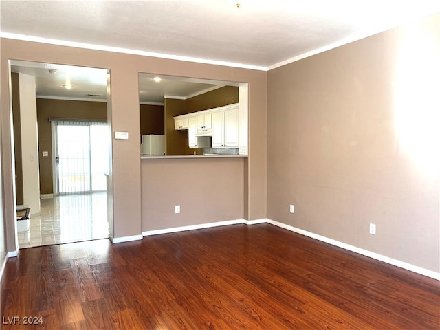 unfurnished living room with crown molding and hardwood / wood-style floors