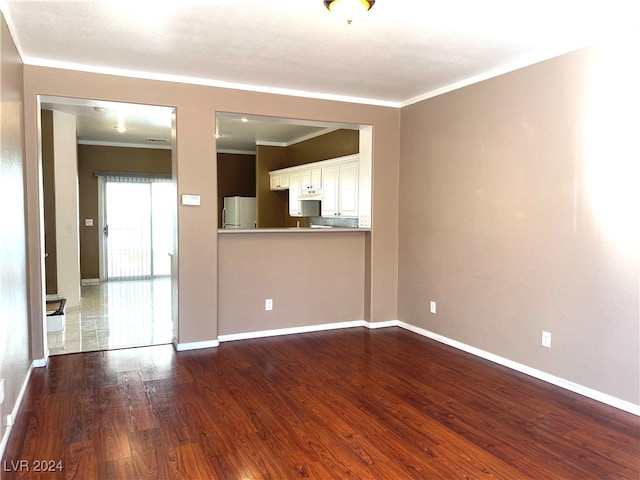 unfurnished living room featuring crown molding and hardwood / wood-style floors