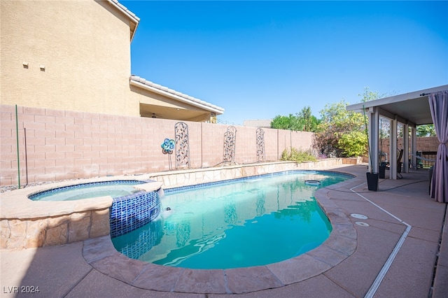 view of swimming pool with an in ground hot tub and a patio area