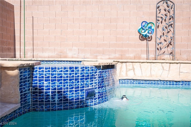 view of pool with pool water feature