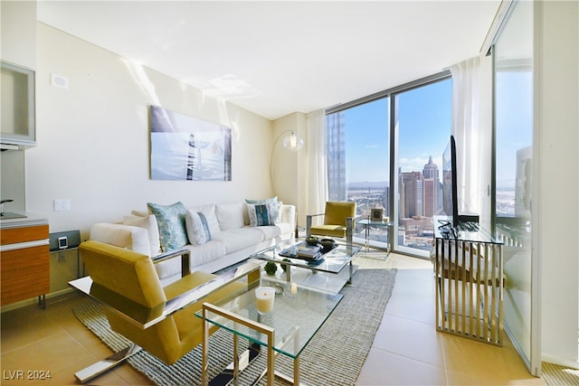 living room with floor to ceiling windows and light tile patterned flooring