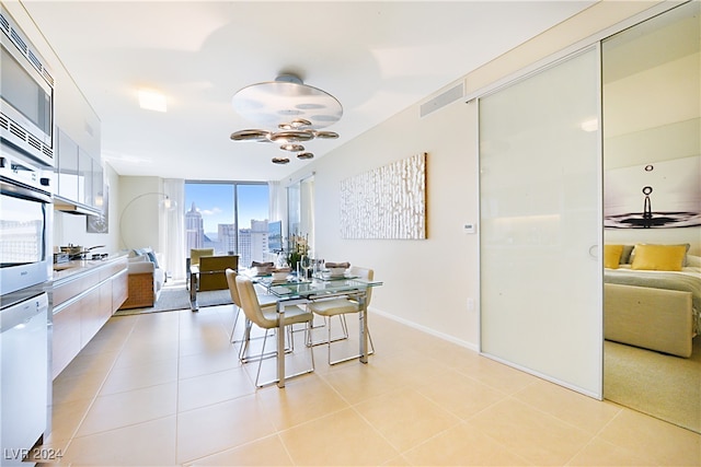 dining space with light tile patterned floors and a healthy amount of sunlight