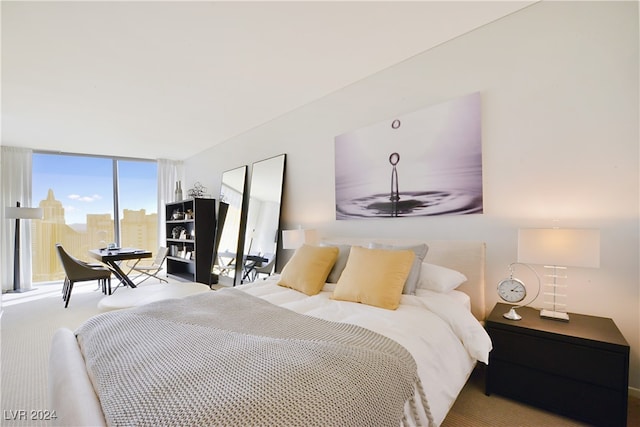 carpeted bedroom with floor to ceiling windows