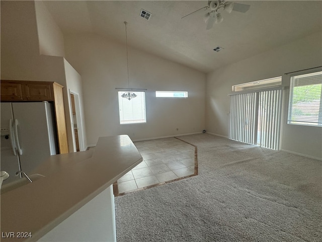 interior space featuring high vaulted ceiling, light colored carpet, and ceiling fan