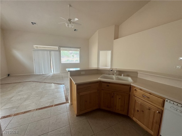 kitchen with white dishwasher, vaulted ceiling, sink, light tile patterned flooring, and ceiling fan