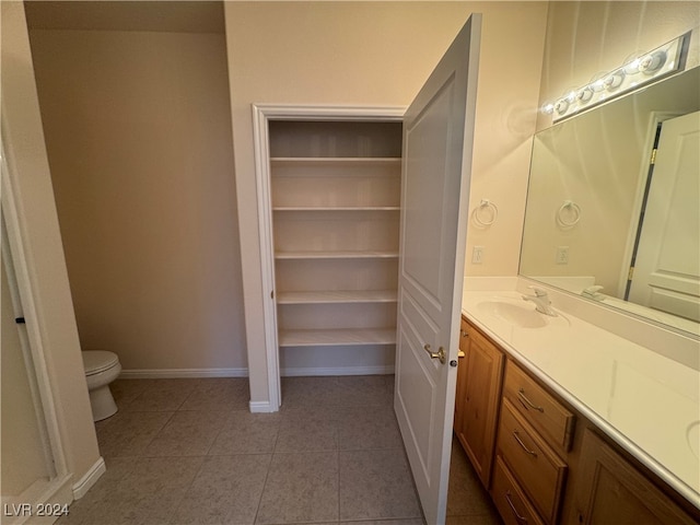 bathroom featuring toilet, vanity, and tile patterned floors