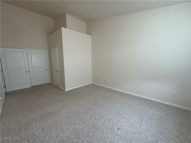 unfurnished bedroom with light colored carpet