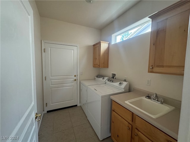 laundry room featuring cabinets, washing machine and dryer, light tile patterned floors, and sink