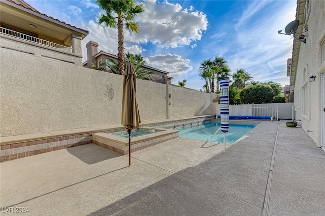 view of pool with a patio area and an in ground hot tub