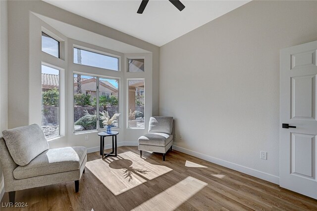 sitting room featuring wood finished floors, baseboards, and ceiling fan