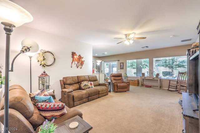 carpeted living room with ceiling fan