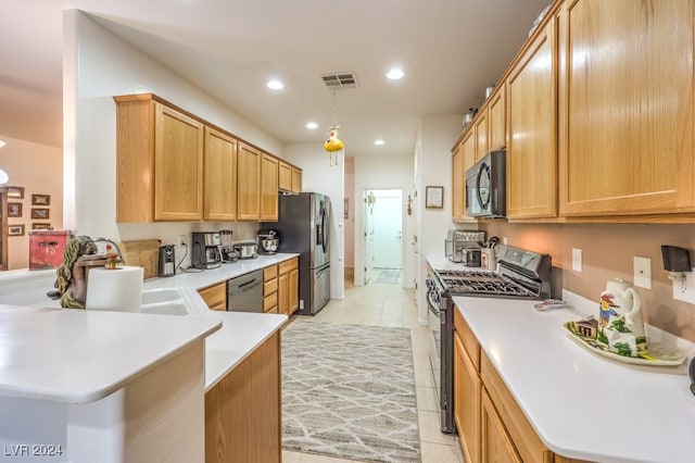 kitchen with kitchen peninsula, hanging light fixtures, light tile patterned flooring, black appliances, and sink