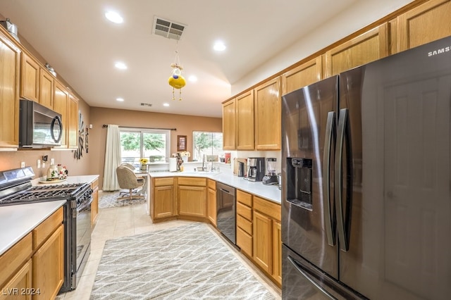 kitchen with black appliances, light tile patterned flooring, and kitchen peninsula