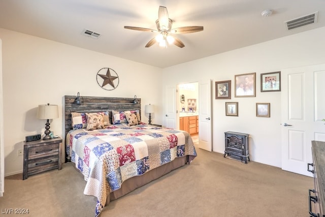 carpeted bedroom featuring ensuite bath and ceiling fan