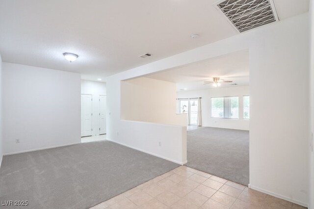 7625 Fieldfare Dr, North Las Vegas, NV 89084 - unfurnished room with light carpet, a ceiling fan, baseboards, and light tile patterned flooring