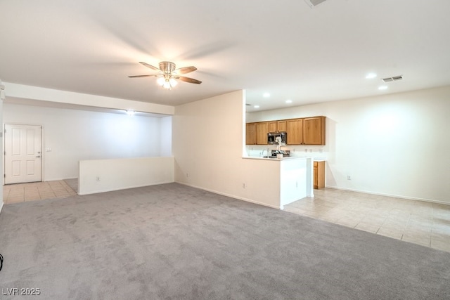 7625 Fieldfare Dr, North Las Vegas, NV 89084 - unfurnished living room with light tile patterned floors, light colored carpet, a ceiling fan, baseboards, and recessed lighting