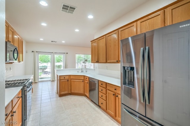 7625 Fieldfare Dr, North Las Vegas, NV 89084 - kitchen with appliances with stainless steel finishes, recessed lighting, a peninsula, a sink, and light countertops