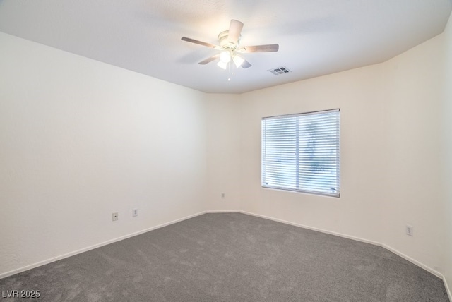 7625 Fieldfare Dr, North Las Vegas, NV 89084 - spare room featuring dark carpet, ceiling fan, and baseboards