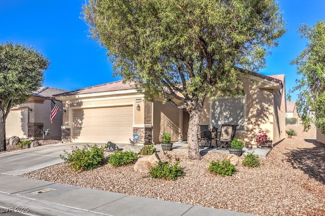 7625 Fieldfare Dr, North Las Vegas, NV 89084 - view of front facade featuring stucco siding, concrete driveway, a garage, and stone siding