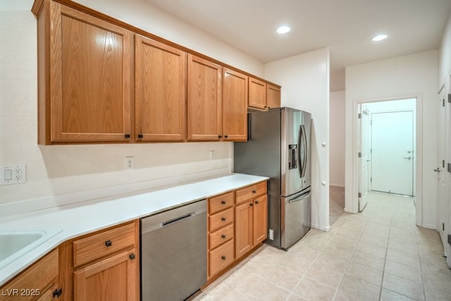 7625 Fieldfare Dr, North Las Vegas, NV 89084 - kitchen featuring stainless steel appliances, light countertops, recessed lighting, light tile patterned flooring, and brown cabinets