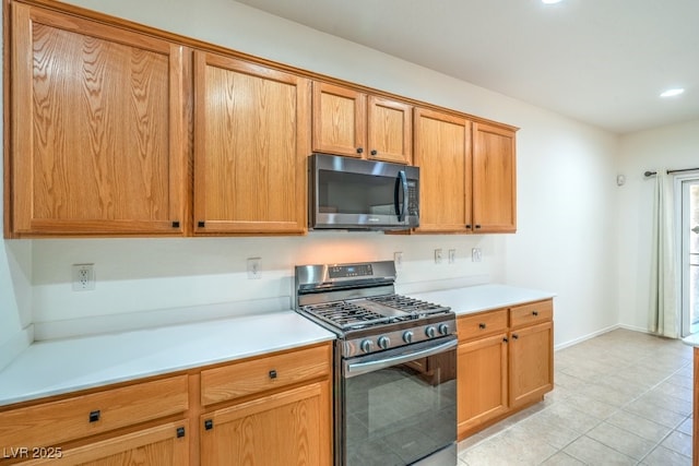 7625 Fieldfare Dr, North Las Vegas, NV 89084 - kitchen featuring gas range, light countertops, recessed lighting, and light tile patterned floors