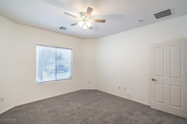 7625 Fieldfare Dr, North Las Vegas, NV 89084 - unfurnished room with dark carpet, ceiling fan, a smoke detector, and baseboards