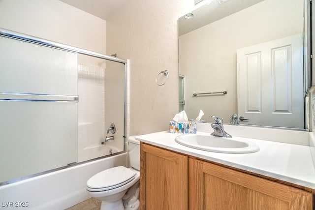 7625 Fieldfare Dr, North Las Vegas, NV 89084 - bathroom featuring vanity, toilet, shower / bath combination with glass door, and tile patterned flooring