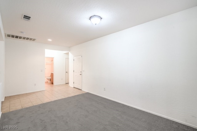 7625 Fieldfare Dr, North Las Vegas, NV 89084 - empty room with carpet flooring, tile patterned flooring, baseboards, and recessed lighting