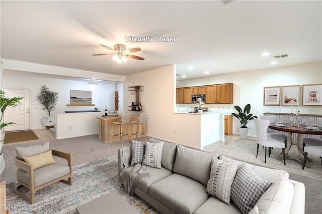 7625 Fieldfare Dr, North Las Vegas, NV 89084 - living room featuring a ceiling fan, recessed lighting, and light colored carpet