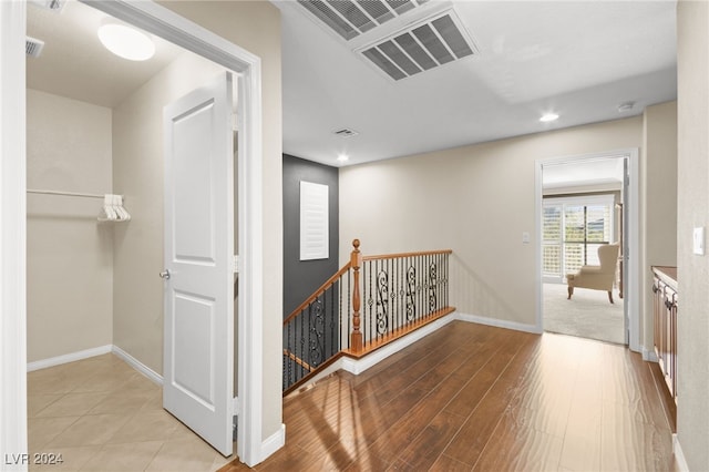 corridor with light hardwood / wood-style flooring