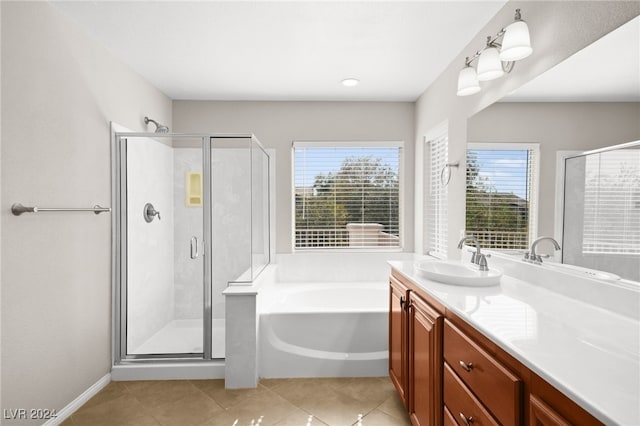 bathroom with tile patterned floors, vanity, and plus walk in shower