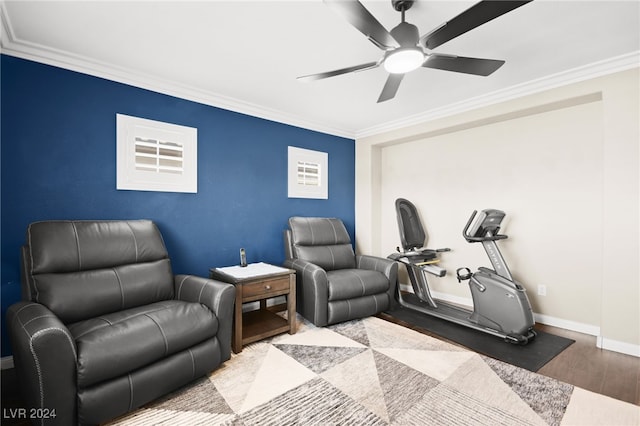 sitting room with ceiling fan, light wood-type flooring, and ornamental molding