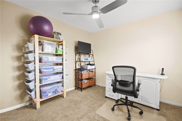 carpeted office space with ceiling fan