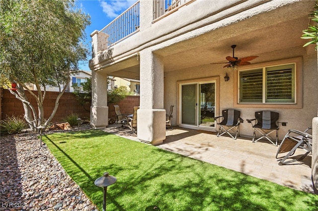 exterior space with ceiling fan, a balcony, and a patio