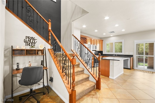 stairs with tile patterned floors