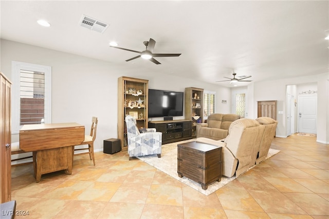 tiled living room featuring ceiling fan